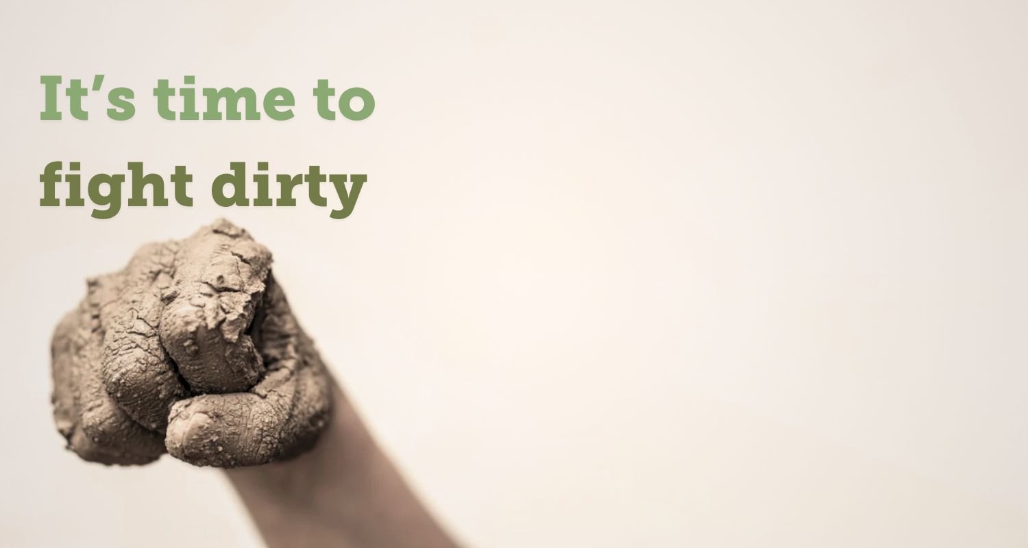 'To beat climate change, we need to fight dirty' text layover next to a hand making in fist, covered in soil